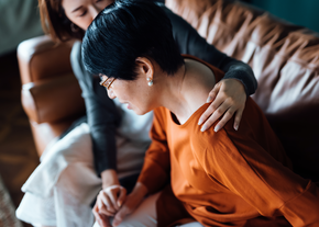A woman helps a mother get up