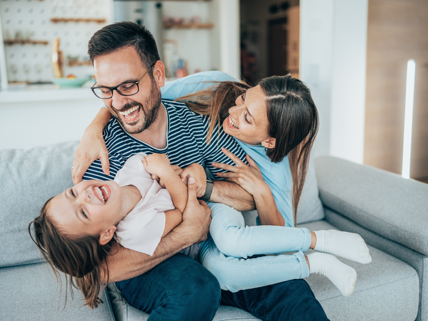 Family playing on sofa