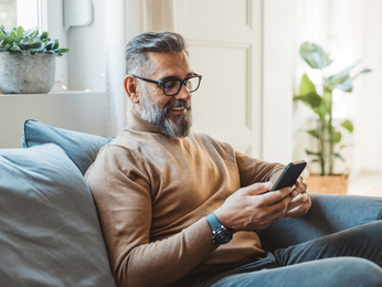Man at home looking at his phone
