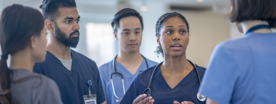 Providers conversing in a hospital.
