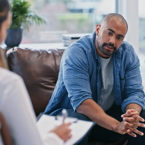 a mature man speaks with a provider