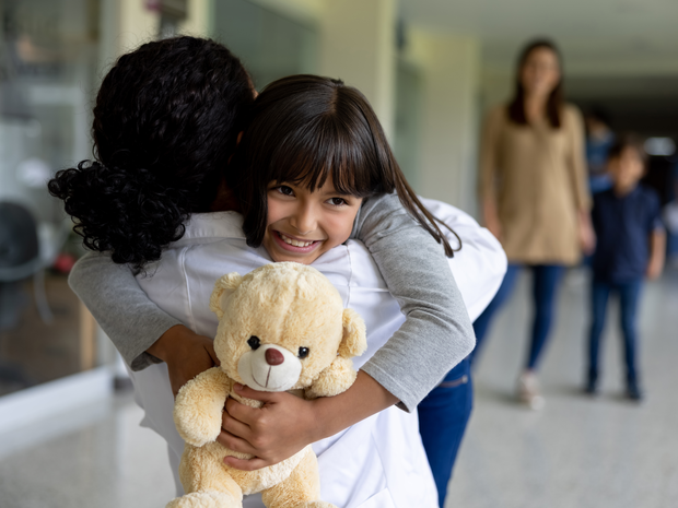 Young woman in wheelchair on the street, smiling.