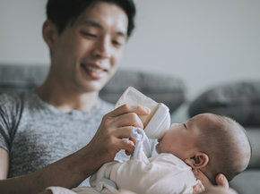 Dad feeding baby with bottle