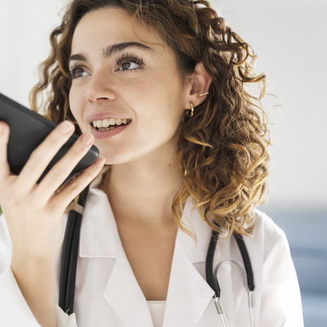 Doctor sending audio note with her mobile phone