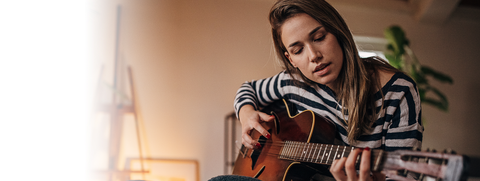A woman playing the guitar