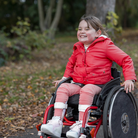 young, happy girl in a wheelchair