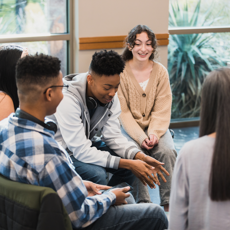 Group of teens sitting in a circle talking