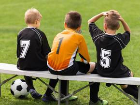 Youth soccer players on the sideline