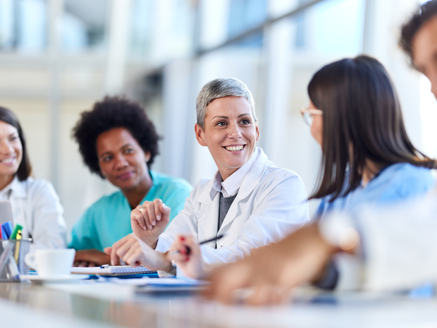Team of happy doctors talking on a meeting in the office.