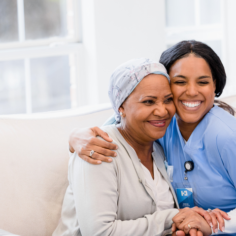 nurse gives hug to a cancer patient