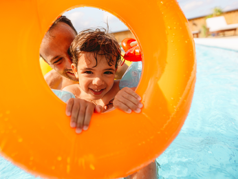 Father and Son playing in a pool