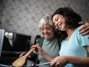 grandmother cooking with her granddaughter