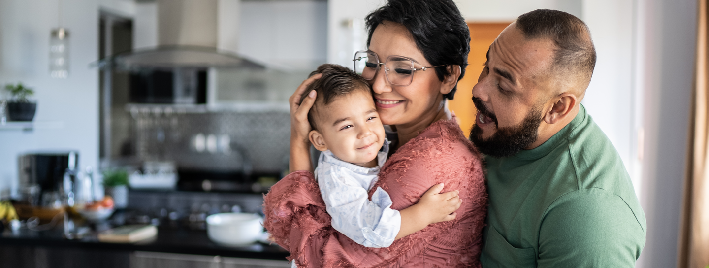Family laughs together at home.