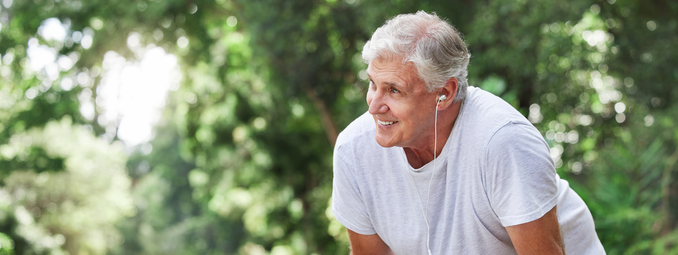 An older man outside jogging