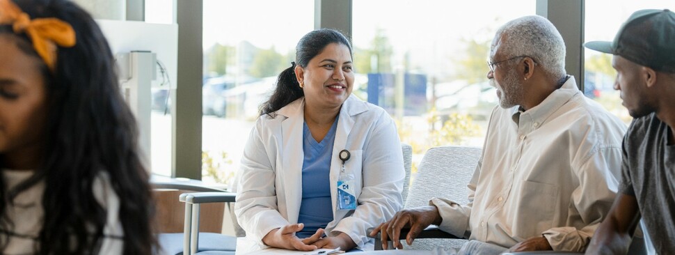 Female doctor discusses medical history with patient 