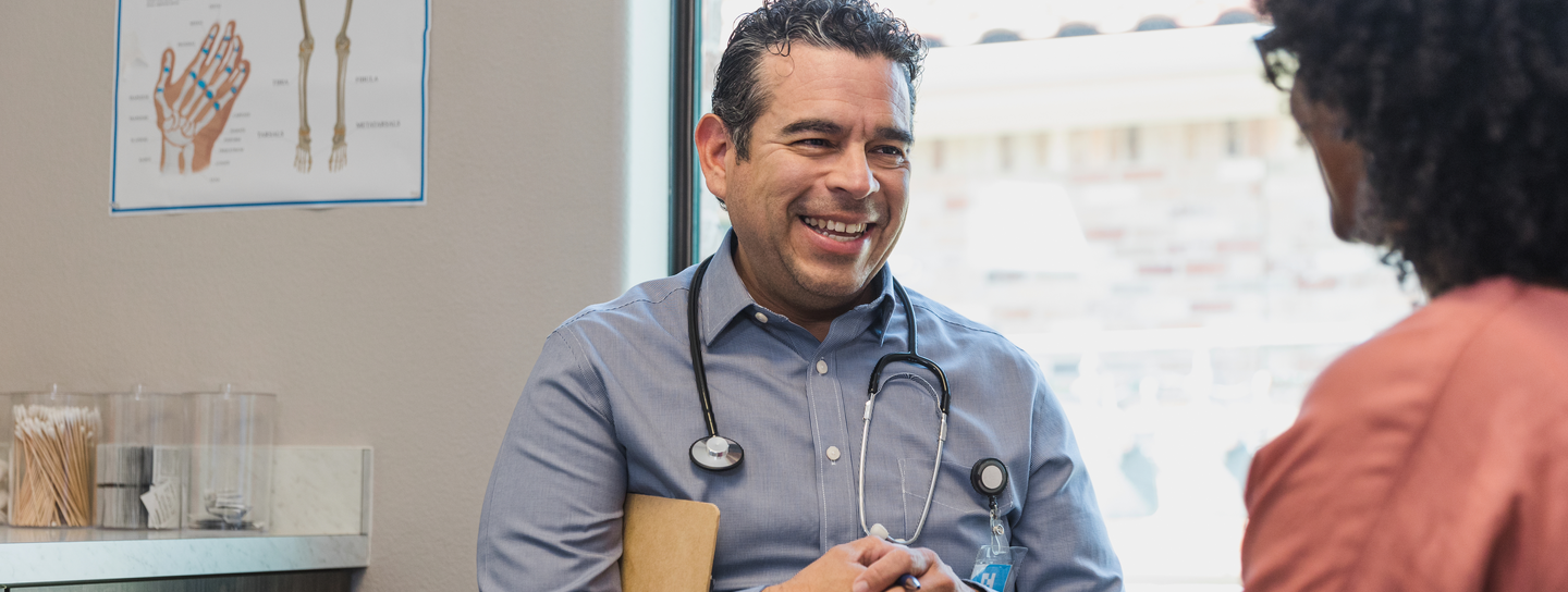 Provider smiles while speaking with patient.