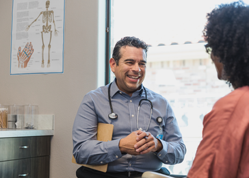 Provider smiles while talking to patient.
