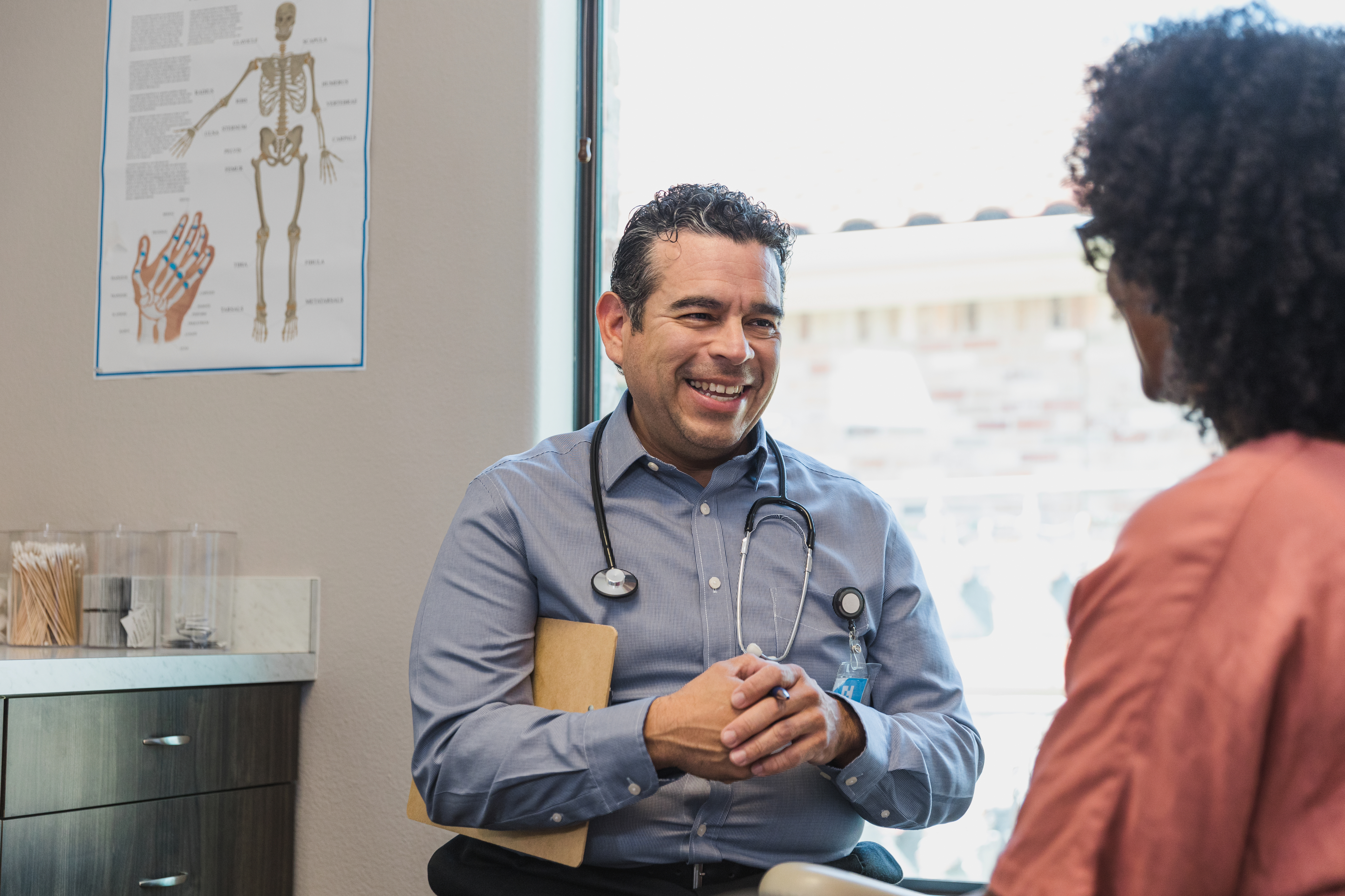 Provider smiles while talking to patient.