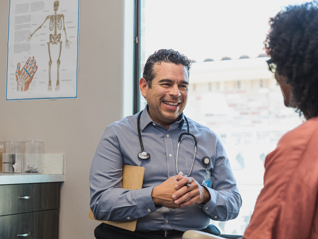 Provider smiles while talking to patient.