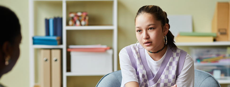 Teenage girl talks to counselor