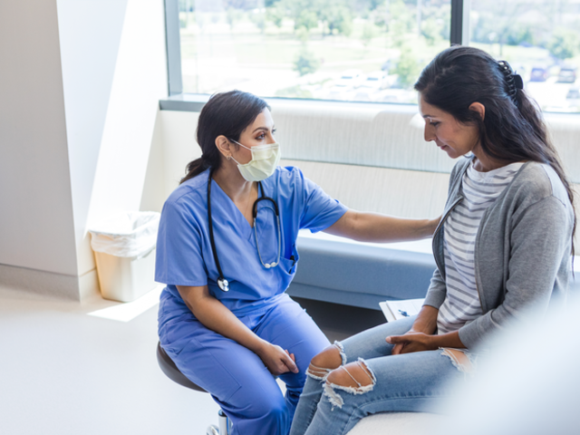 Female nurse comforts young woman