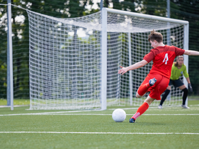 Soccer player shooting the ball during a match