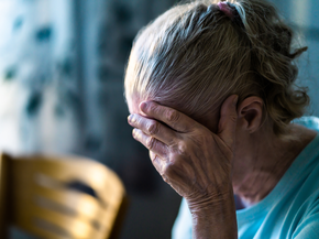 woman holds her head