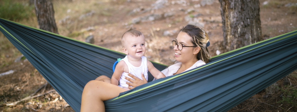 Mother and baby enjoying a hammock while camping.