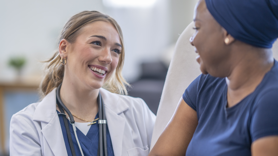 Provider smiles while supporting patient.