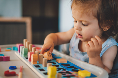 Young child playing with puzzle