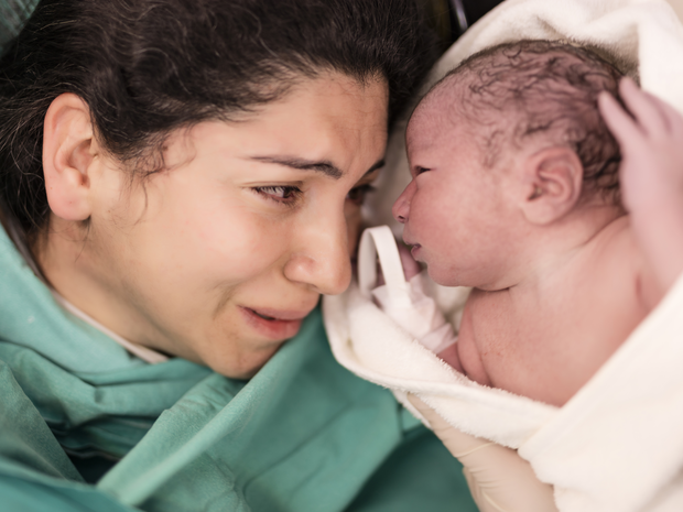 Mother and her newborn baby in operating room
