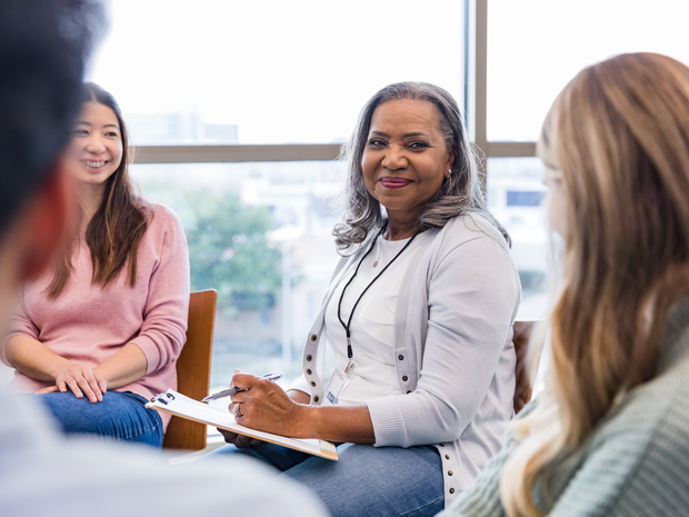 Group of participants speak in a circle.