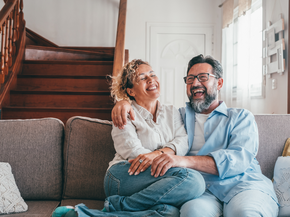 Mature couple laughing in their living room