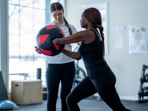 Patient and therapist in gym