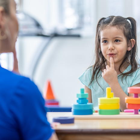 young girl works with a speech therapist