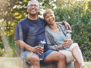 Older couple smiling while stopping on a walk