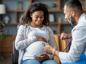 Pregnant african american woman speaking with doctor