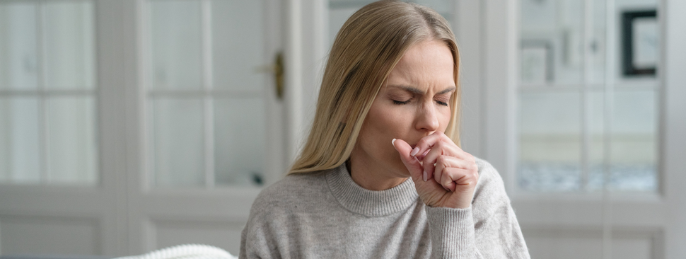 Young woman coughing