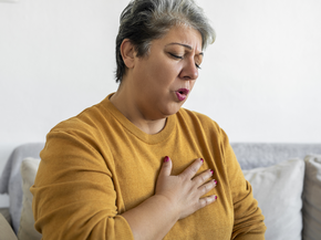 woman out of breath and holding her chest