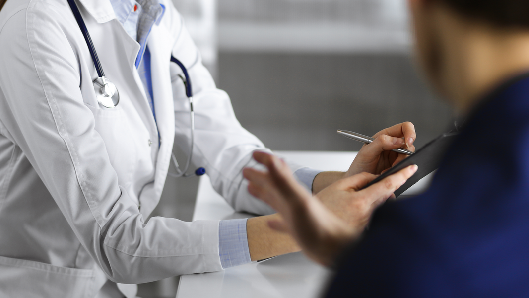 Provider writes down notes on tablet.
