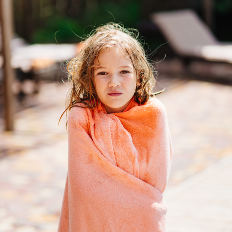 Little girl wrapped in a pink towel