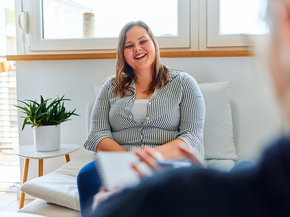 A happy woman is talking to her health coach