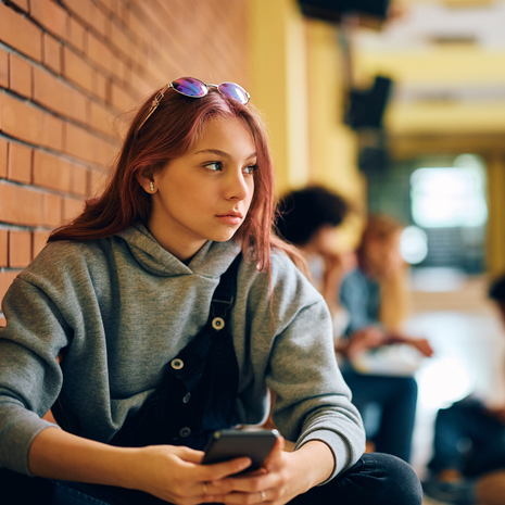 Teenage girl at school with classmates