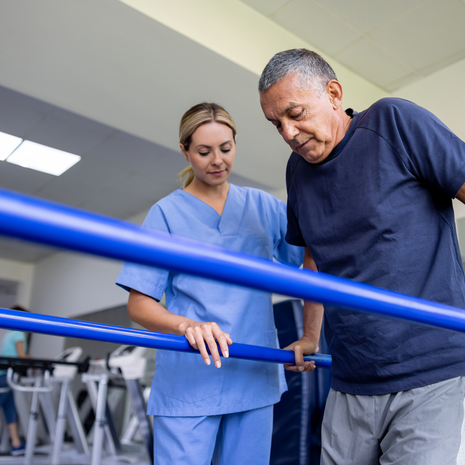 Mature man working with physical therapist after orthopedic surgery