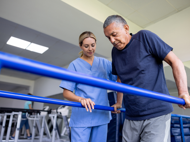 Older man doing physical therapy with provider.