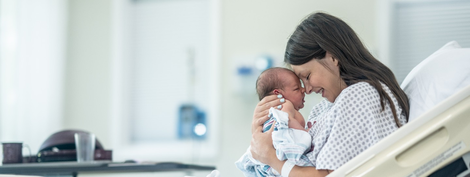 Mother embraces newly born child