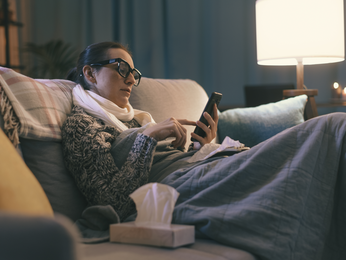 Woman looking at her phone on the couch