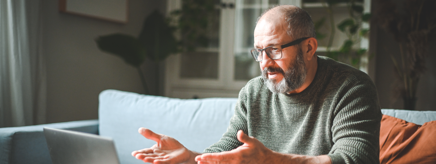 mature man using a laptop at home