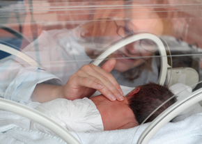 A nurse attends to a NICU baby
