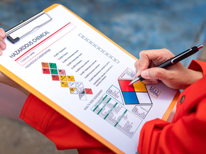A safety engineer is using pen to rating the health risk assessment level of chemical hazardous material in the paperwork form. Industrial safety working scene, close-up and selective focus.
